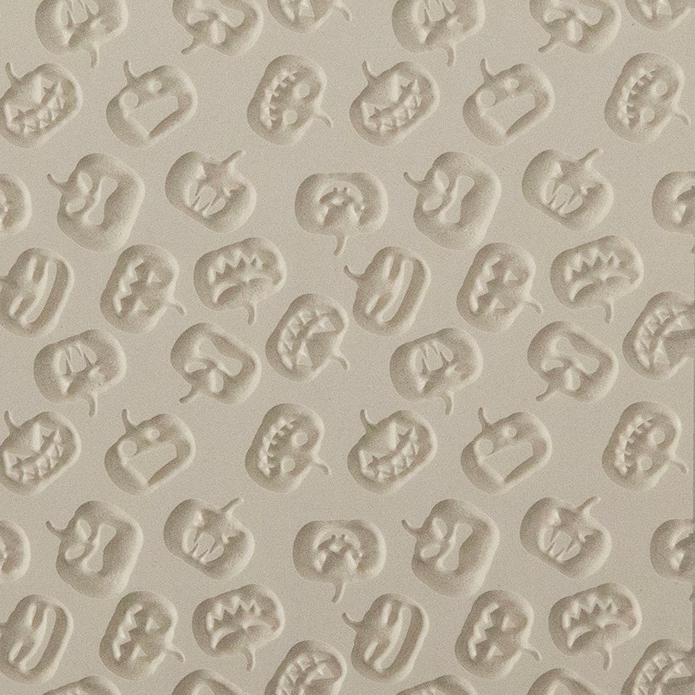 Texture Tile - Carved Pumpkins Embossed. Beige Texture Tiles are flexible, washable and can be used with any soft clay. Spritz with CoolSlip or dust on Dry Powder Release for stick-free impressions when using metal clay and polymer clay.