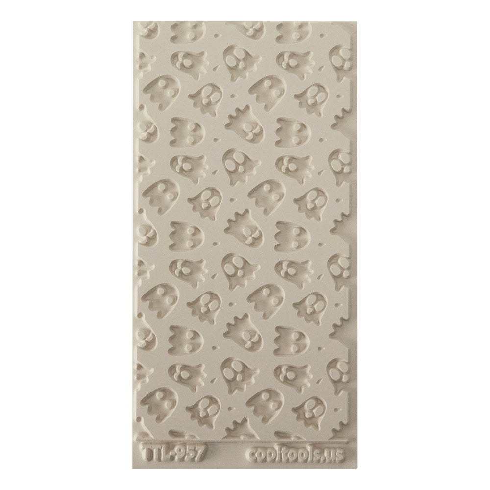 Texture Tile - Ghoulfriends Embossed. Beige Texture Tiles are flexible, washable and can be used with any soft clay. Spritz with CoolSlip or dust on Dry Powder Release for stick-free impressions when using metal clay and polymer clay.