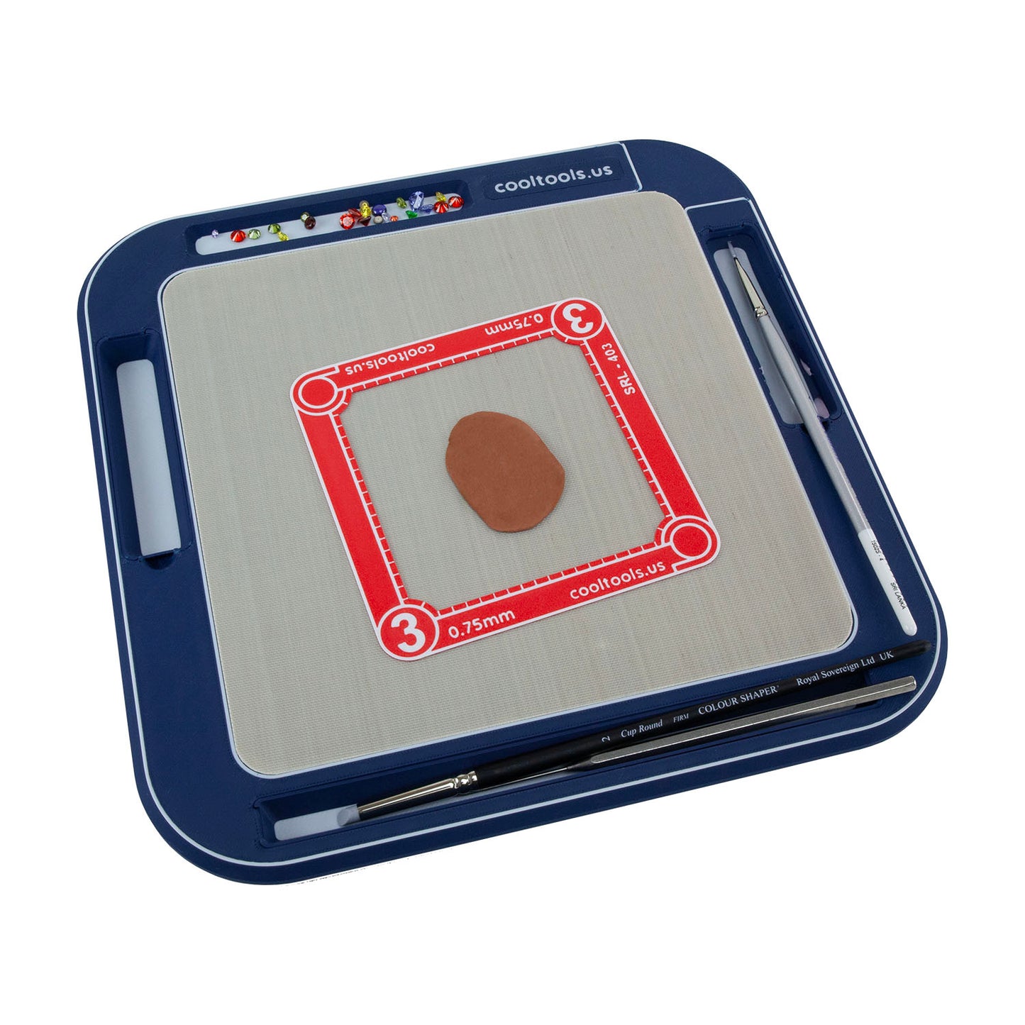 8x8 blue Non-Stick Clayboard WorkStation filled with czs, water and brush, clay shaper, ultra clay pick, rolling frame and rolled out copper clay.