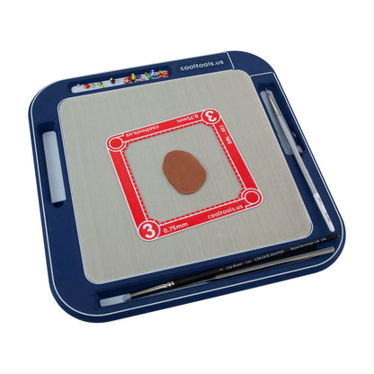 8x8 blue Non-Stick Clayboard WorkStation filled with czs, water and brush, clay shaper, ultra clay pick, rolling frame and rolled out copper clay.
