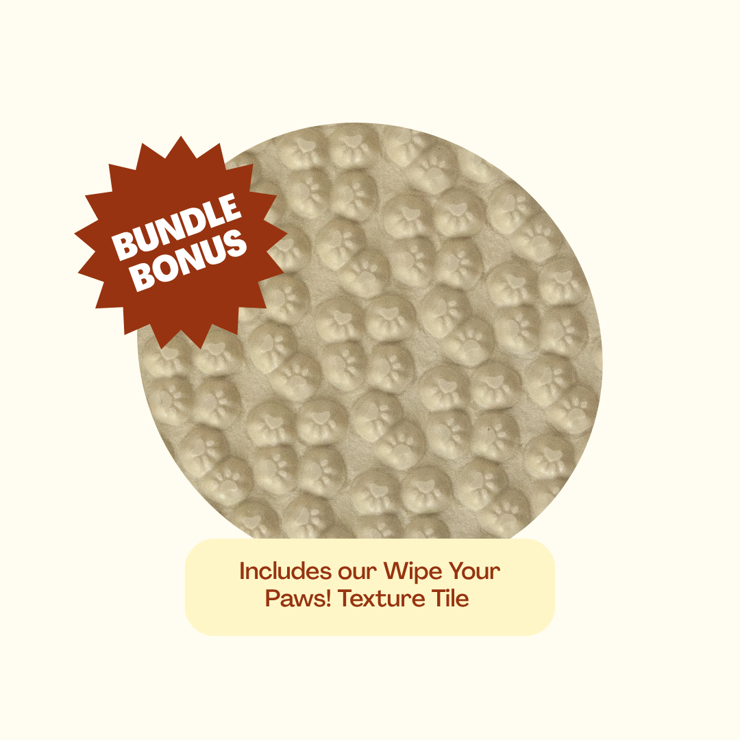 A circular beige textured paw-print tile with a red starburst label reading 'BUNDLE BONUS' and a cream label below that says 'Includes our Wipe Your Paws! Texture Tile' on a light cream background.