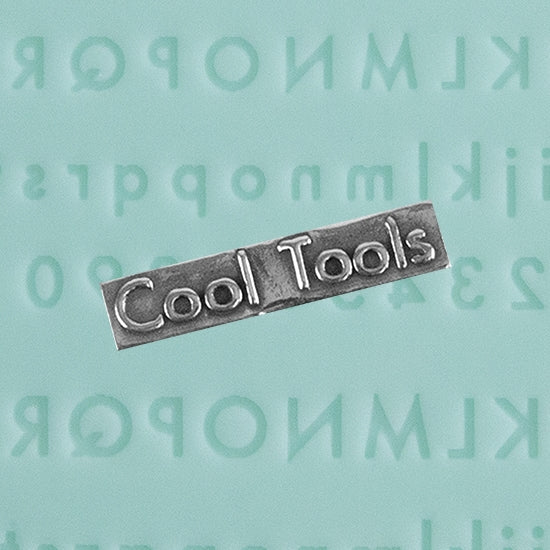 Finishing Touches Mold - Alphabet 1 Flat with silver sample - Cool Tools Finishing Touches are silicone molds specially designed to create precise and repeatable shapes and adornments for metal clay and polymer clay. Each mold is complete with each letter of the alphabet and numbers 0 through 9 - perfectly calibrated for jewelry and jewelry components.  