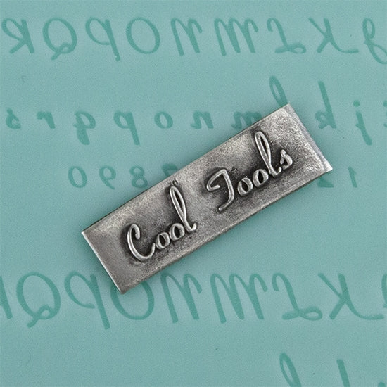 Finishing Touches Mold - Alphabet 4 - Flat  with  silver sample Cool Tools Finishing Touches are silicone molds specially designed to create precise and repeatable shapes and adornments for metal clay and polymer clay. Each mold is perfectly calibrated for jewelry and jewelry components.