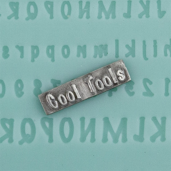 Finishing Touches Mold - Alphabet 5 - Flat with silver sample Cool Tools Finishing Touches are silicone molds specially designed to create precise and repeatable shapes and adornments for metal clay and polymer clay. Each mold is perfectly calibrated for jewelry and jewelry components.