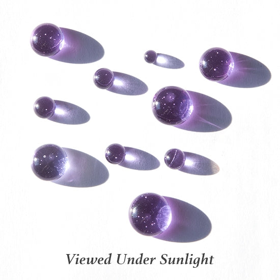 Colored Glass Cabochon - Neo Lavender - Round in various sizes viewed under sunlight