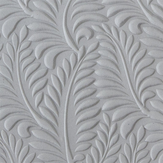 sample in clay of Mega Texture Tile - Crown Fern Embossed. Use to impress texture in soft clays. Mega Texture Tiles are perfect for projects both large and small. Mega Tiles measure 9-1/4" x 6" and are about 7 times larger than Texture Tiles. These textures are flexible, washable and can be used with any soft clay.