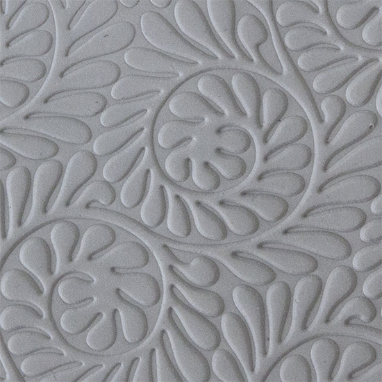 sample in clay of Mega Texture Tile - Fiddlehead Fern Embossed. Use to impress texture in soft clays. Mega Texture Tiles are perfect for projects both large and small. Mega Tiles measure 9-1/4" x 6" and are about 7 times larger than Texture Tiles. These textures are flexible, washable and can be used with any soft clay.