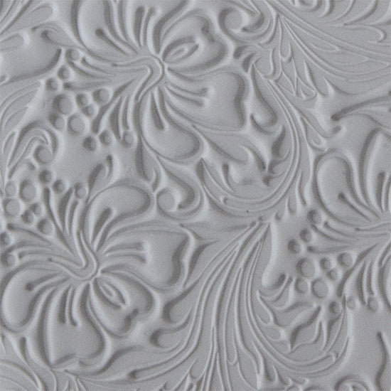 sample in clay of Mega Texture Tile - Hibiscus. Use to impress texture in soft clays. Mega Texture Tiles are perfect for projects both large and small. Mega Tiles measure 9-1/4" x 6" and are about 7 times larger than Texture Tiles. These textures are flexible, washable and can be used with any soft clay.