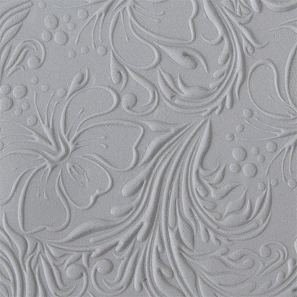 sample in clay of Mega Texture Tile - Hibiscus Embossed. Use to impress texture in soft clays. Mega Texture Tiles are perfect for projects both large and small. Mega Tiles measure 9-1/4" x 6" and are about 7 times larger than Texture Tiles. These textures are flexible, washable and can be used with any soft clay.