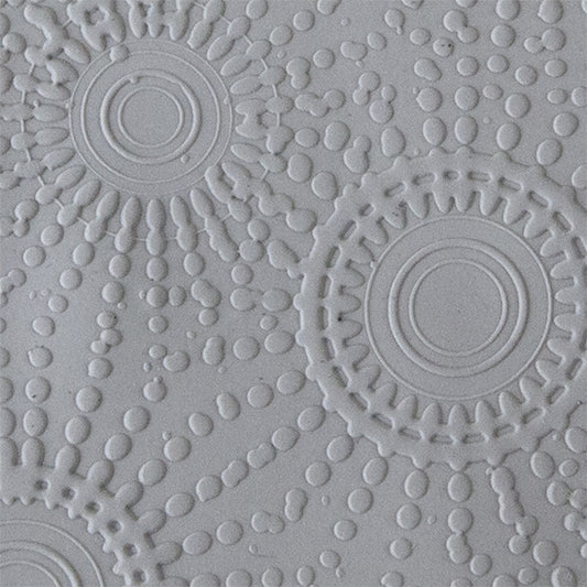 sample in clay of Mega Texture Tile - Sun Spots Embossed. Use to impress texture in soft clays. Mega Texture Tiles are perfect for projects both large and small. Mega Tiles measure 9-1/4" x 6" and are about 7 times larger than Texture Tiles. These textures are flexible, washable and can be used with any soft clay.