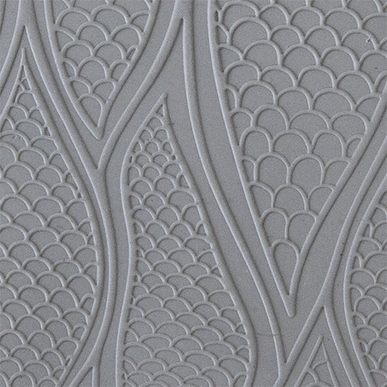 sample in clay of Mega Texture Tile - Be Scaled Embossed. Use to impress texture in soft clays. Mega Texture Tiles are perfect for projects both large and small. Mega Tiles measure 9-1/4" x 6" and are about 7 times larger than Texture Tiles. These textures are flexible, washable and can be used with any soft clay.