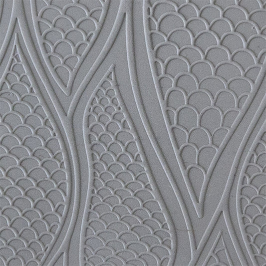 sample in clay of Mega Texture Tile - Be Scaled Embossed. Use to impress texture in soft clays. Mega Texture Tiles are perfect for projects both large and small. Mega Tiles measure 9-1/4" x 6" and are about 7 times larger than Texture Tiles. These textures are flexible, washable and can be used with any soft clay.