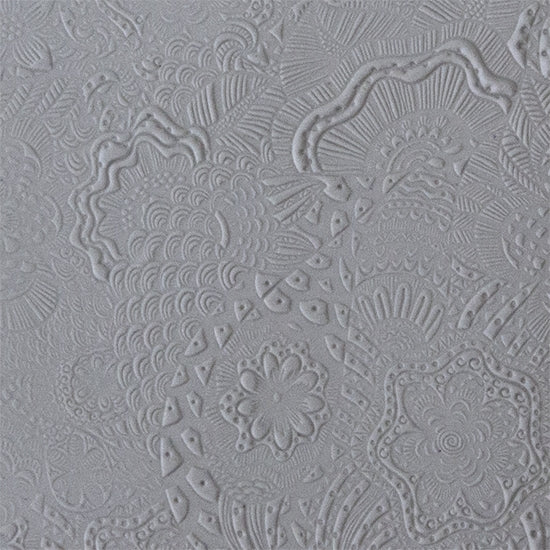 sample in clay of Mega Texture Tile - Flower Power. Use to impress texture in soft clays. Mega Texture Tiles are perfect for projects both large and small. Mega Tiles measure 9-1/4" x 6" and are about 7 times larger than Texture Tiles. These textures are flexible, washable and can be used with any soft clay.