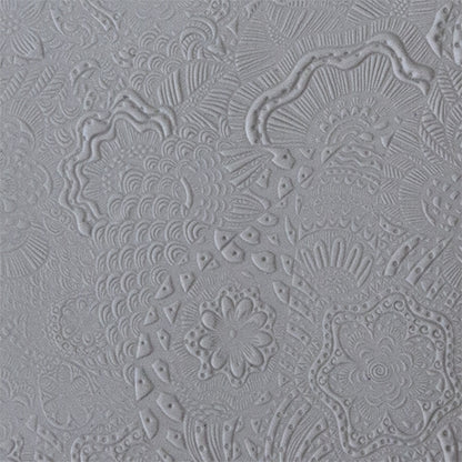sample in clay of Mega Texture Tile - Flower Power. Use to impress texture in soft clays. Mega Texture Tiles are perfect for projects both large and small. Mega Tiles measure 9-1/4" x 6" and are about 7 times larger than Texture Tiles. These textures are flexible, washable and can be used with any soft clay.