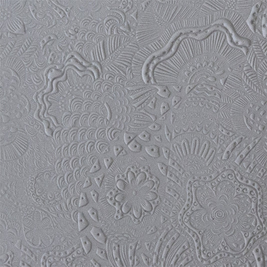 sample in clay of Mega Texture Tile - Flower Power. Use to impress texture in soft clays. Mega Texture Tiles are perfect for projects both large and small. Mega Tiles measure 9-1/4" x 6" and are about 7 times larger than Texture Tiles. These textures are flexible, washable and can be used with any soft clay.