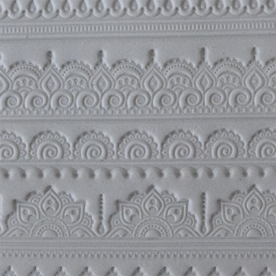 sample in clay of Mega Texture Tile - Mehndi Borders. Use to impress texture in soft clays. Mega Texture Tiles are perfect for projects both large and small. Mega Tiles measure 9-1/4" x 6" and are about 7 times larger than Texture Tiles. These textures are flexible, washable and can be used with any soft clay.