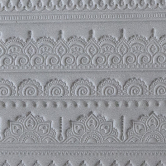 sample in clay of Mega Texture Tile - Mehndi Borders. Use to impress texture in soft clays. Mega Texture Tiles are perfect for projects both large and small. Mega Tiles measure 9-1/4" x 6" and are about 7 times larger than Texture Tiles. These textures are flexible, washable and can be used with any soft clay.