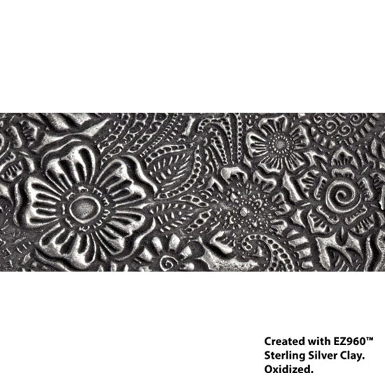 silver sample of Mega Texture Tile - Daisy Paisley. Use to impress texture in soft clays. Mega Texture Tiles are perfect for projects both large and small. Mega Tiles measure 9-1/4" x 6" and are about 7 times larger than Texture Tiles. These textures are flexible, washable and can be used with any soft clay.