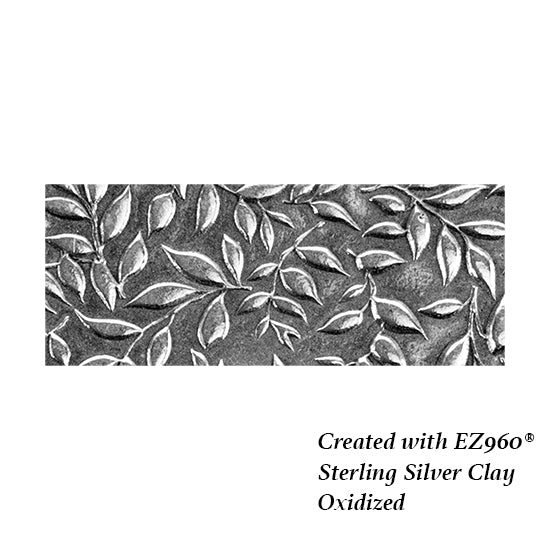 silver sample of Mega Texture Tile - Simple Leaves Embossed. Use to impress texture in soft clays. Mega Texture Tiles are perfect for projects both large and small. Mega Tiles measure 9-1/4" x 6" and are about 7 times larger than Texture Tiles. These textures are flexible, washable and can be used with any soft clay.