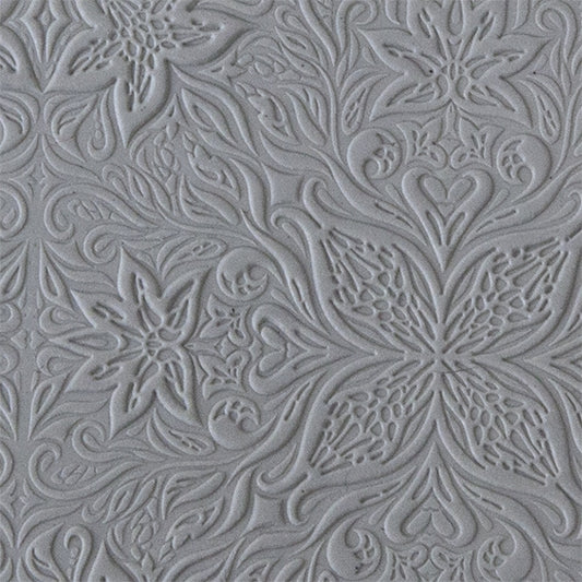 sample in clay of Mega Texture Tile - Woodcut Floral Embossed. Use to impress texture in soft clays. Mega Texture Tiles are perfect for projects both large and small. Mega Tiles measure 9-1/4" x 6" and are about 7 times larger than Texture Tiles. These textures are flexible, washable and can be used with any soft clay.