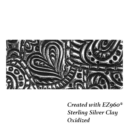 silver sample of Mega Texture Tile - Doodling Hearts. Use to impress texture in soft clays. Mega Texture Tiles are perfect for projects both large and small. Mega Tiles measure 9-1/4" x 6" and are about 7 times larger than Texture Tiles. These textures are flexible, washable and can be used with any soft clay.