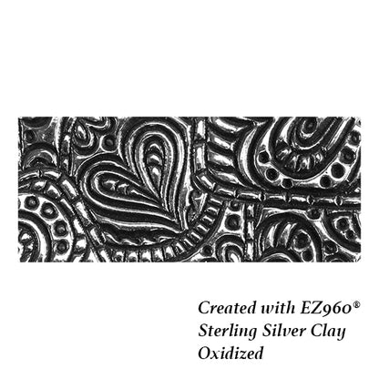 silver sample of Mega Texture Tile - Doodling Hearts. Use to impress texture in soft clays. Mega Texture Tiles are perfect for projects both large and small. Mega Tiles measure 9-1/4" x 6" and are about 7 times larger than Texture Tiles. These textures are flexible, washable and can be used with any soft clay.
