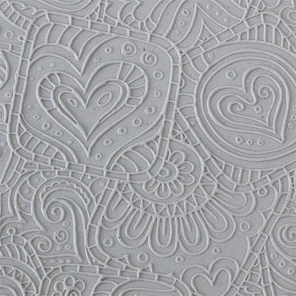 sample in clay of Mega Texture Tile - Doodling Hearts Fineline. Use to impress texture in soft clays. Mega Texture Tiles are perfect for projects both large and small. Mega Tiles measure 9-1/4" x 6" and are about 7 times larger than Texture Tiles. These textures are flexible, washable and can be used with any soft clay.