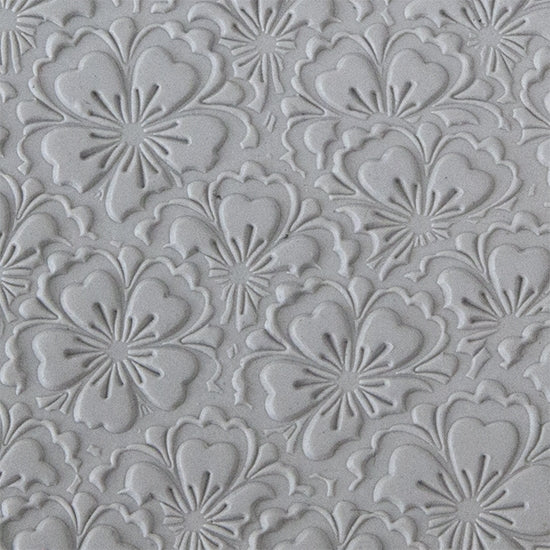 sample in clay of Mega Texture Tile - Flowering Fields. Use to impress texture in soft clays. Mega Texture Tiles are perfect for projects both large and small. Mega Tiles measure 9-1/4" x 6" and are about 7 times larger than Texture Tiles. These textures are flexible, washable and can be used with any soft clay.