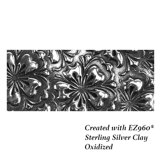 silver sample of Mega Texture Tile - Flowering Fields. Use to impress texture in soft clays. Mega Texture Tiles are perfect for projects both large and small. Mega Tiles measure 9-1/4" x 6" and are about 7 times larger than Texture Tiles. These textures are flexible, washable and can be used with any soft clay.