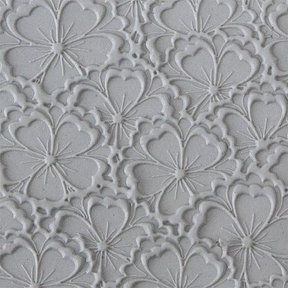 sample in clay of Mega Texture Tile - Flowering Fields Embossed. Use to impress texture in soft clays. Mega Texture Tiles are perfect for projects both large and small. Mega Tiles measure 9-1/4" x 6" and are about 7 times larger than Texture Tiles. These textures are flexible, washable and can be used with any soft clay.