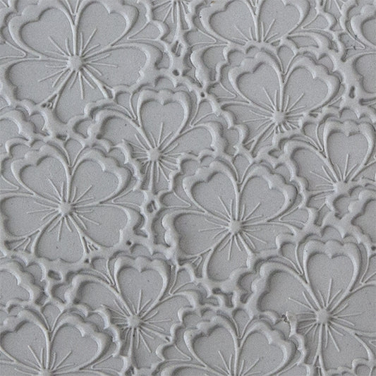 sample in clay of Mega Texture Tile - Flowering Fields Embossed. Use to impress texture in soft clays. Mega Texture Tiles are perfect for projects both large and small. Mega Tiles measure 9-1/4" x 6" and are about 7 times larger than Texture Tiles. These textures are flexible, washable and can be used with any soft clay.