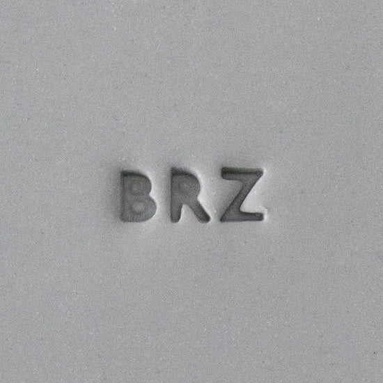 Quality Stamp for Wet Clay - BRZ - 2mm 1-5/8" long BRZ quality marking stamp for wet clay. A "quality mark" is the little number or letters that indicate what metal and purity is used in an item made of a precious metal. By law, this stamp can only be used to mark an item that is made from Bronze. Each stamp has been calibrated with placement, legibility and shrinkage of clay in mind. Sized at just 2mm x 5.6mm, placement is easier than ever. impression in clay