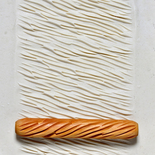 Wooden Hand Roller - Diagonal Ridges rolled into white clay