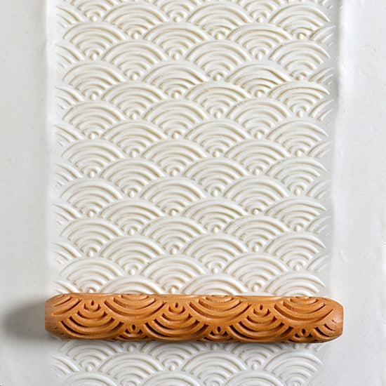 Wooden Hand Roller - Waves rolled into white clay