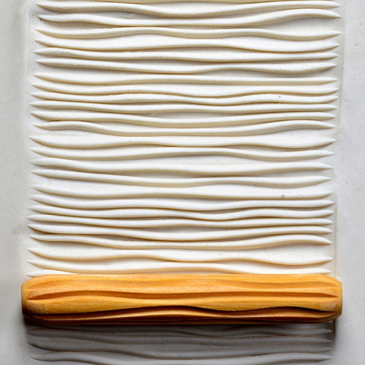 Wooden Hand Roller - Horizontal Lines  rolled into white clay