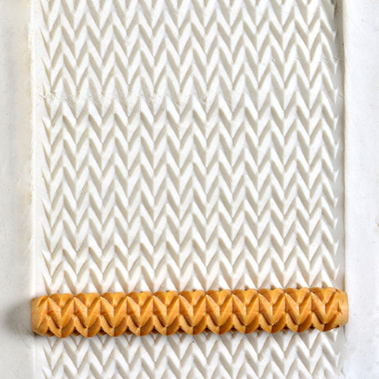 Wooden Hand Roller - Zigzag rolled into white clay