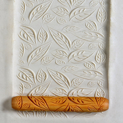 Wooden Clay Rollers rolled into white clay