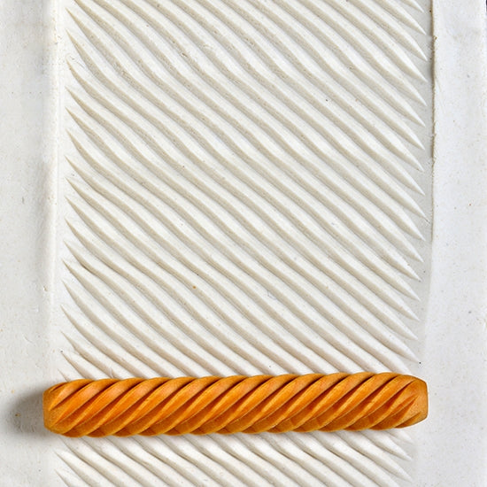 Wooden Hand Roller - Diagonal rolled into white clay