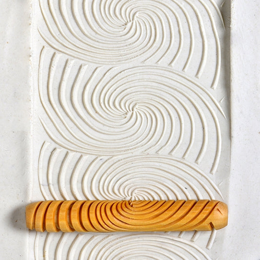 Wooden Hand Roller - Galactic Spiral rolled into white clay