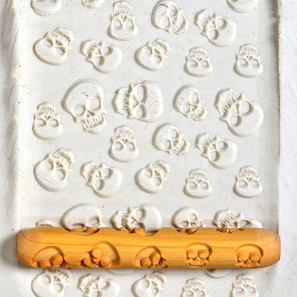 Wooden Hand Roller - Skulls rolled into white clay
