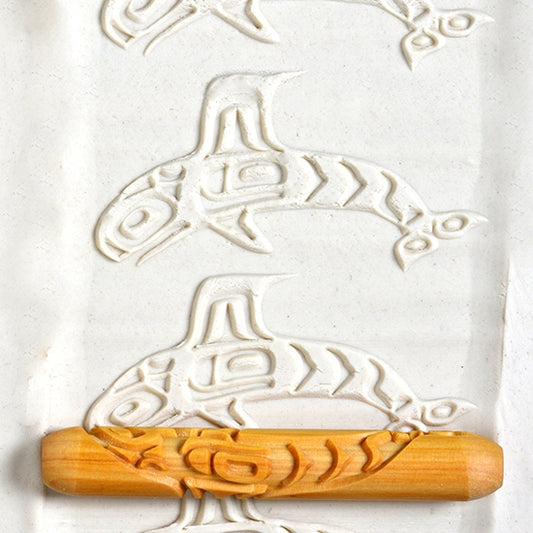 Wooden Hand Roller - Orca rolled into white clay