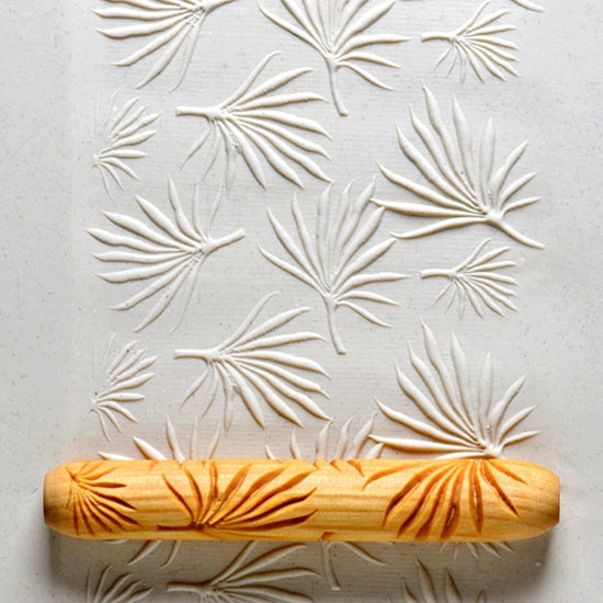 Wooden Hand Roller - Palmetto Garden rolled into white clay