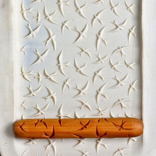 Wooden Hand Roller - Swooping Swallows rolled into white clay