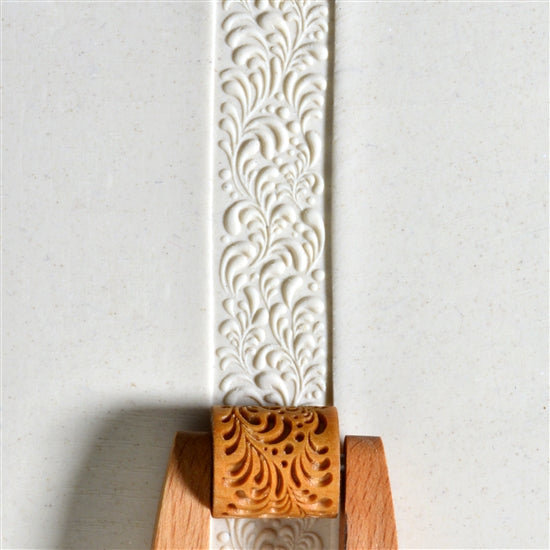 Wooden Mini Roller - Funky Floral 20mm rolled into white clay