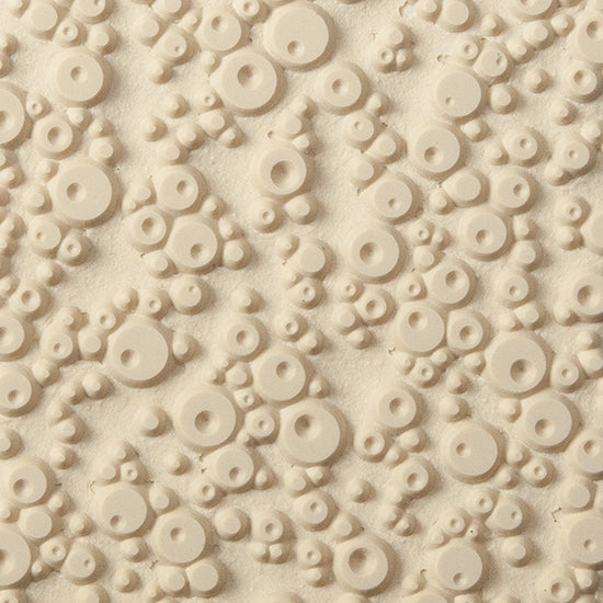 Texture Tile - Double Bubble. Beige Texture Tiles are flexible, washable and can be used with any soft clay. Spritz with CoolSlip or dust on Dry Powder Release for stick-free impressions when using metal clay and polymer clay.