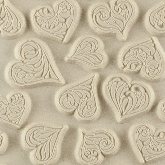 Texture Tile - Heartbreaker. Beige Texture Tiles are flexible, washable and can be used with any soft clay. Spritz with CoolSlip or dust on Dry Powder Release for stick-free impressions when using metal clay and polymer clay.