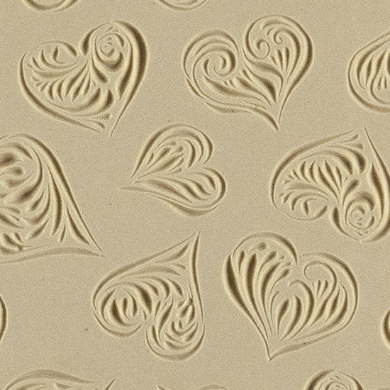 Texture Tile - Heartbreaker Embossed. Beige Texture Tiles are flexible, washable and can be used with any soft clay. Spritz with CoolSlip or dust on Dry Powder Release for stick-free impressions when using metal clay and polymer clay.