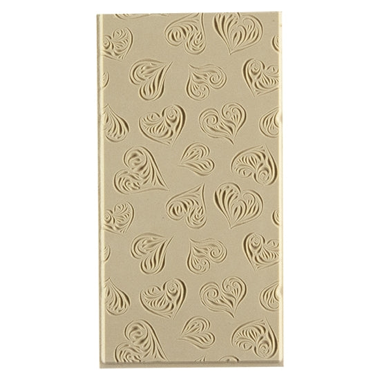 Texture Tile - Heartbreaker Embossed. Beige Texture Tiles are flexible, washable and can be used with any soft clay. Spritz with CoolSlip or dust on Dry Powder Release for stick-free impressions when using metal clay and polymer clay.