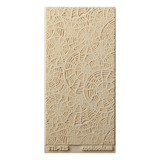 Texture Tile - Nautilus. Beige Texture Tiles are flexible, washable and can be used with any soft clay. Spritz with CoolSlip or dust on Dry Powder Release for stick-free impressions when using metal clay and polymer clay.