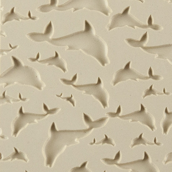 Texture Tile - Flying Dolphins Embossed. Beige Texture Tiles are flexible, washable and can be used with any soft clay. Spritz with CoolSlip or dust on Dry Powder Release for stick-free impressions when using metal clay and polymer clay.